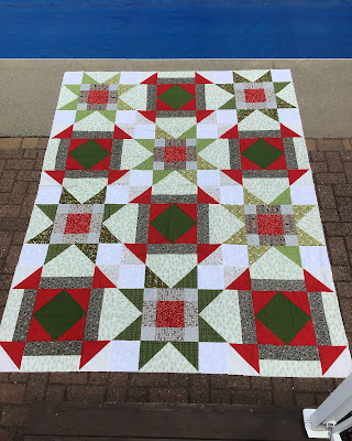 Starlight quilt in Christmas fabrics Starlight Sew Joy Creations