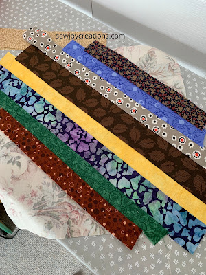 toning down the yellow with dark prints scrap prints and yellow strip block