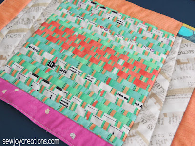 I love the faux-weaved selvages and the herringbone text. Carrie Bloomston's latest fabric called Story. closeup of quilting on Bold Delight