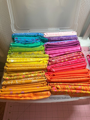 Alison Glass fabrics folded in scrapbook storage box