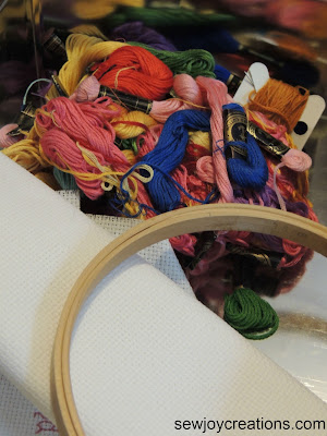 closeup embroidery floss wood hoop and aida cloth anchor embroidery floss