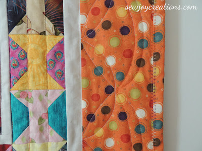 I love machine quilting my binding and using the same fabric as the border to make it almost invisible! closeup of border and machine binding