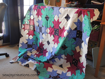 ironing the Dazzle quilt top Dazzle Quilt Sew Joy Creations