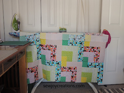 pinning another row to the Dropping In quilt Dropping In quilt pinning on ironing board