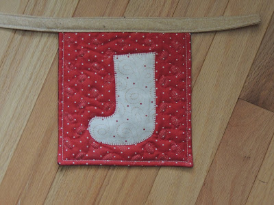 free motion stocking complete red background stocking free motion quilting stocking banner QUILTsocial project