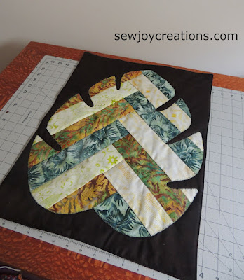 giant fabric leaf appliqued to black background