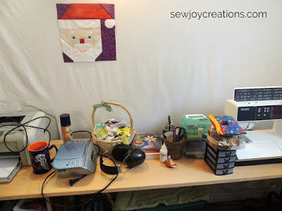 little things stored in hutch stashed on quilting table containers waiting for new homes