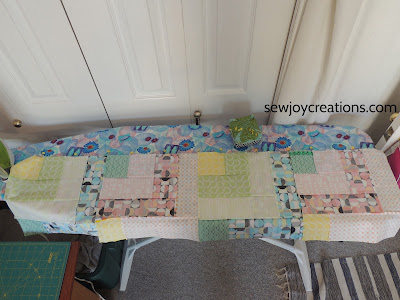 Dropping In quilt almost fits length of ironing board pinning quilt rows Good Vibes fabric Dropping In quilt
