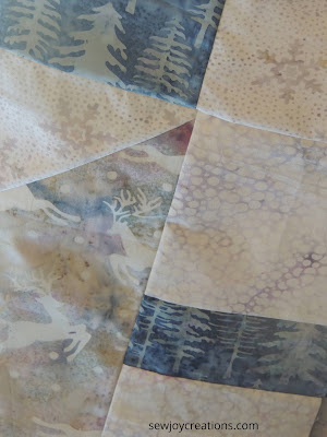Prancing reindeer and blue evergreen tree fabrics