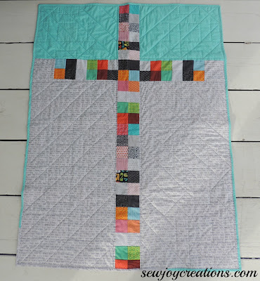 two patch leftovers made into a cross for reverse side of baby quilt back of quilt two patch cross