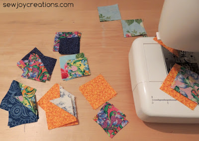 Block pieces piled beside the machine ready for their turn sea shell block units left to sew