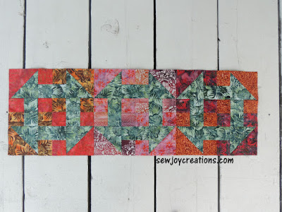 three Churn Baby Churns made into a tablerunner churn dash runner batik project Banyan batiks
