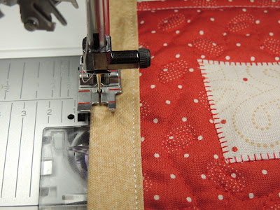 stitching the binding to the front of the banner stocking banner binding string QUILTsocial project