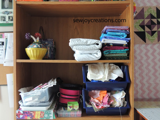 functional middle shelve of bookcase with open space sewing room bookcase folded fabric scrap bins
